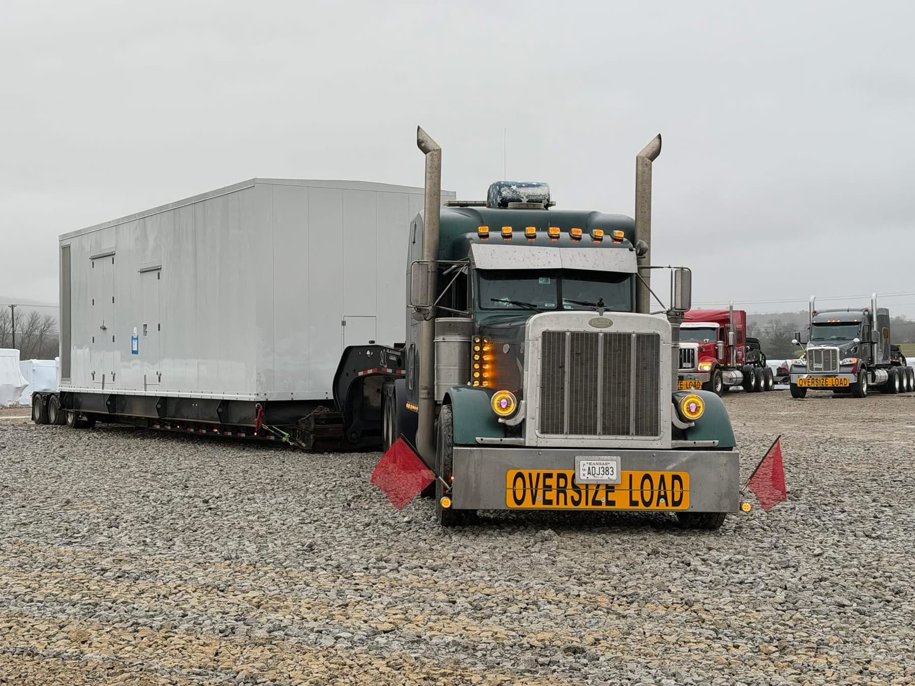 Green Peterbilt with oversize modular unit